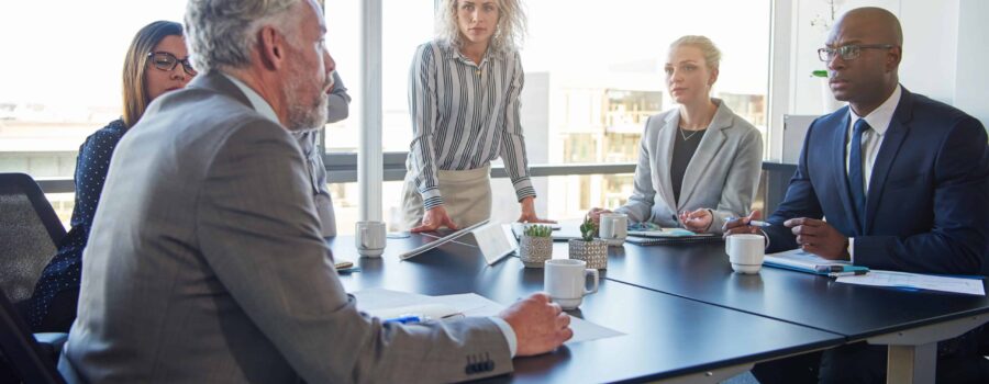 colleagues talking strategy together in a modern office setting