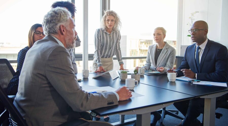 colleagues talking strategy together in a modern office setting