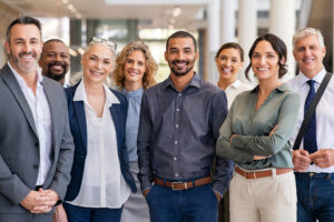 Portrait of successful group of business people at modern office looking at camera