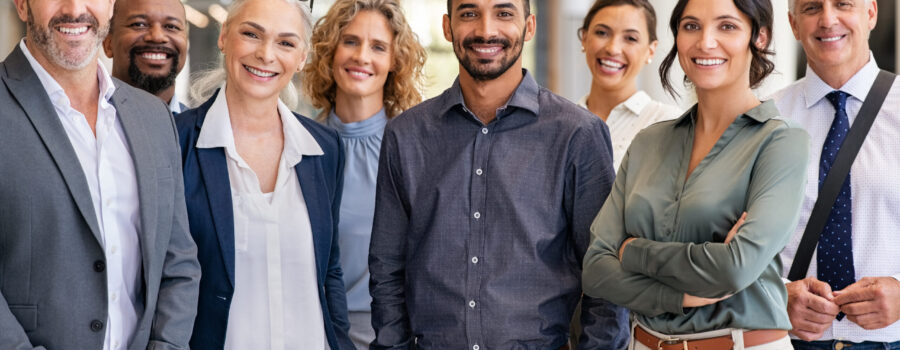 Portrait of successful group of business people at modern office looking at camera