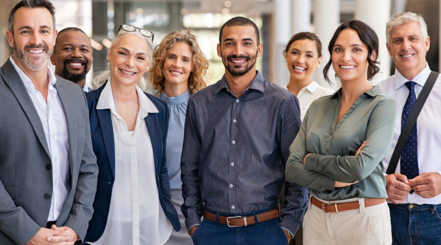 Portrait of successful group of business people at modern office looking at camera