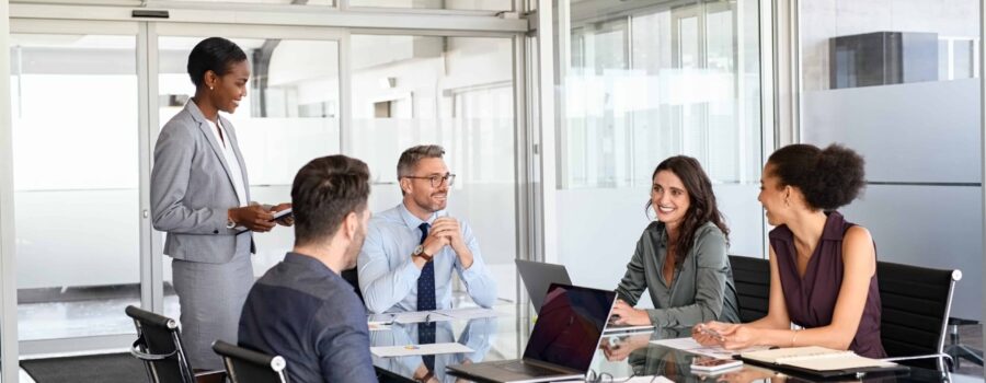 Business colleagues meeting around a table in glass office